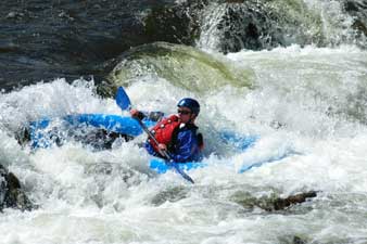 Kayaking down a rapid on the Roaring Fork